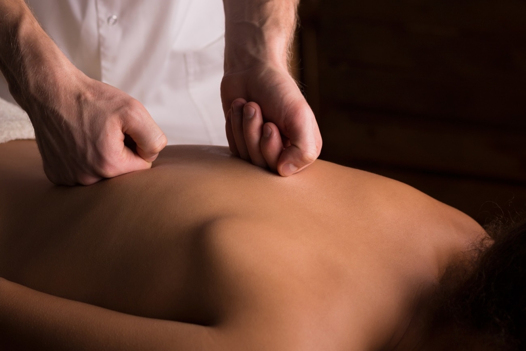 Male hands doing back massage